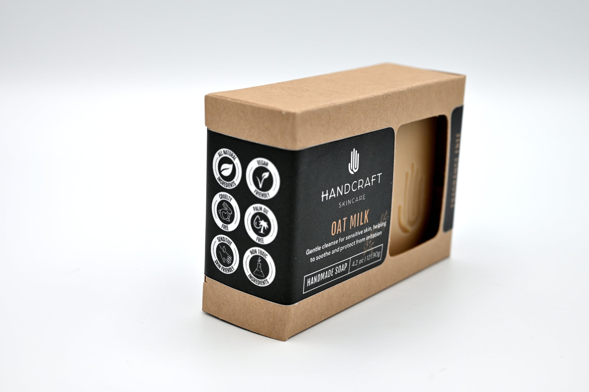 packaged taupe colored oat milk soap in a Kraft box with a black label and white logos stating all natural ingredients, vegan friendly, cruelty free, palm oil free, sensitive skin friendly and non toxic ingredients